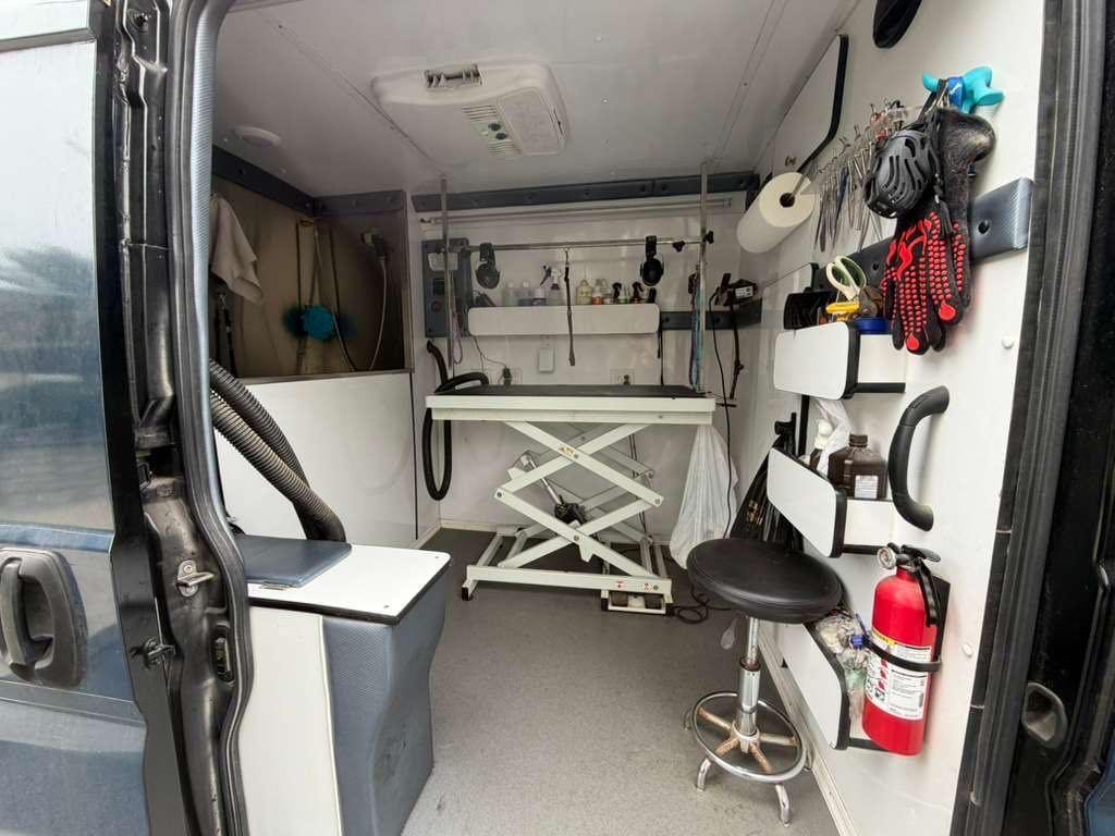 Inside the Wonder Pets grooming van: lift table, bath area, dryer and pro tool station